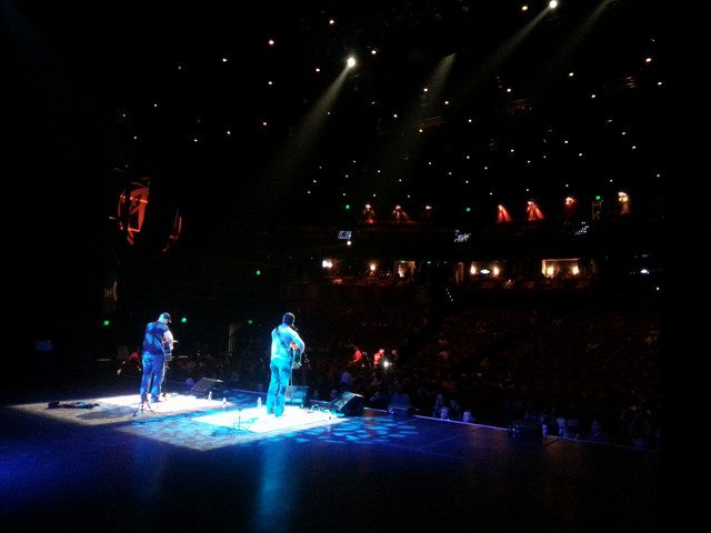 Arena stage with blue lights, shot from behind