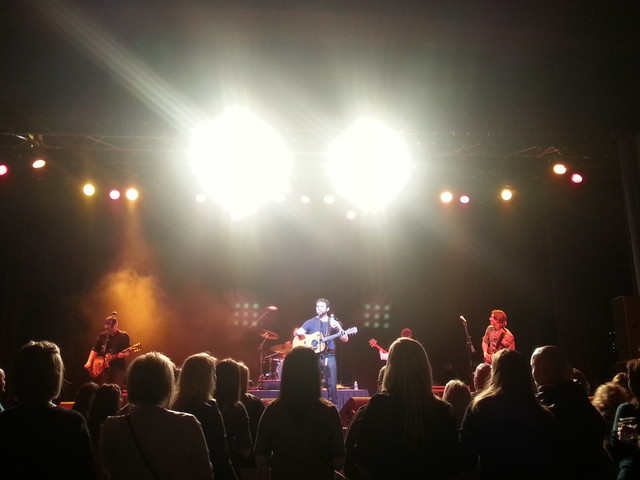 Bright stage lights — full band performing