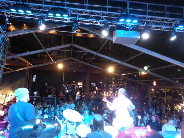 Indoor venue with blue truss lighting
